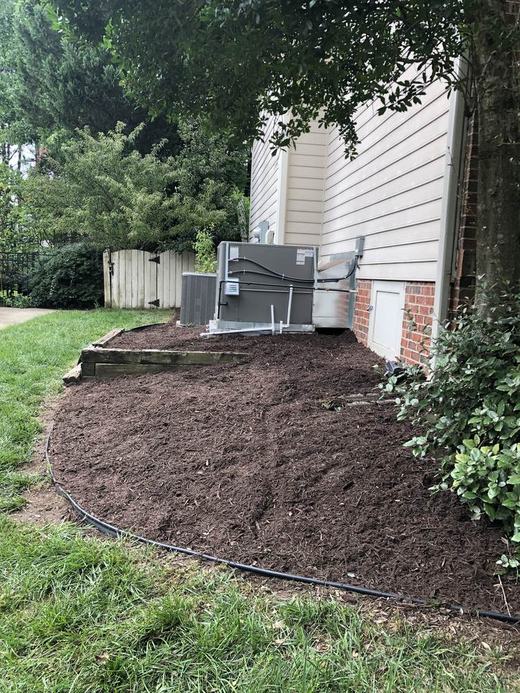 Fresh mulch bed around AC unit after service